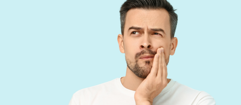 Man experiencing tooth discomfort, highlighting the importance of preventive dental care at Broad St Smiles in San Luis Obispo, CA.