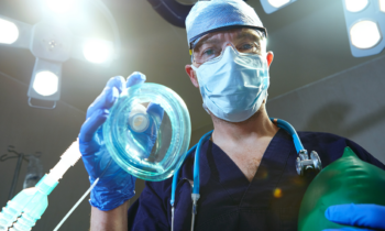 Dental professional preparing sedation equipment for patient comfort at Broad St Smiles in San Luis Obispo, CA.